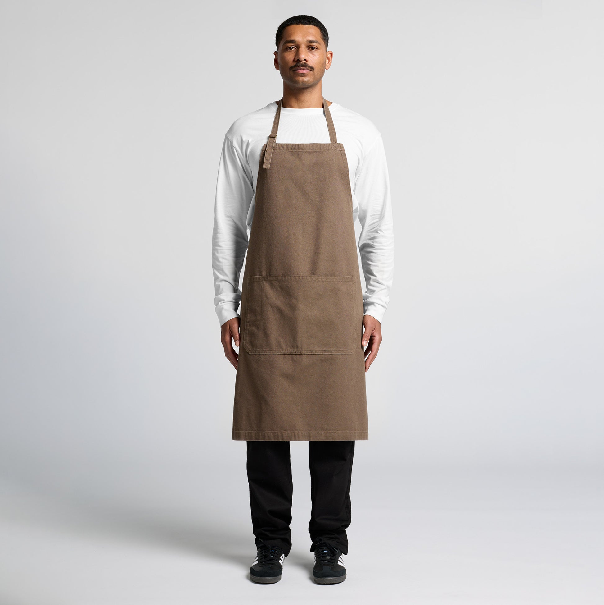 man in white long sleeve  wearing an as colour colour cotton duck canvas apron in brown