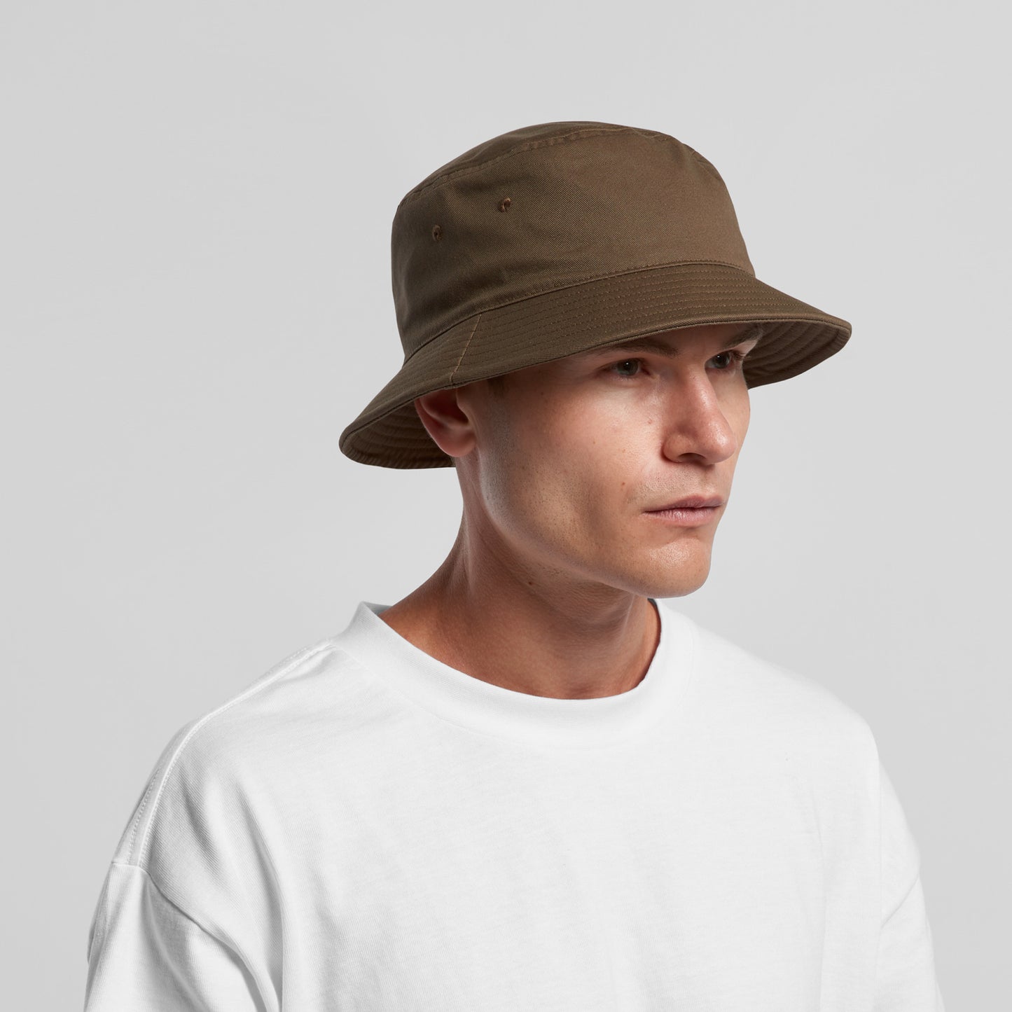 man in white tshirt wearing an as colour colour cotton bucket hat in walnut brown